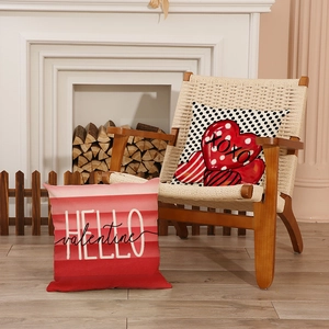 Valentine's Day pillow covers with XOXO heart and Hello Valentine text on a cozy chair