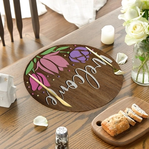 Detailed close-up of a floral linen placemat with welcome lettering and tulip print