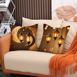 Set of 2 golden Ramadan throw pillow covers with moon and lantern patterns on sofa