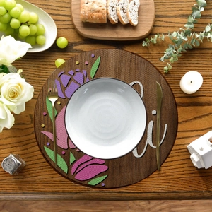 Flat lay of linen round placemat with tulip patterns, rustic table setting with cutlery