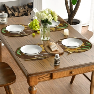 Detail of round linen placemats with sunflower pattern and heat-resistant woven texture