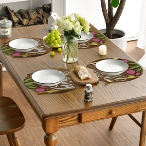 Set of 4 round linen placemats with pink tulips and Hello Spring text on wood table