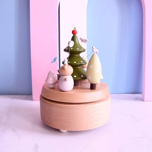 Handcrafted wooden music box featuring forest animals and butterfly decorations