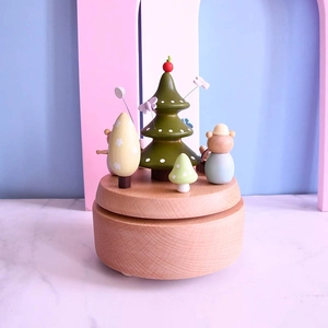 Handcrafted wooden music box featuring a cute bear and trees in soft pastel colors
