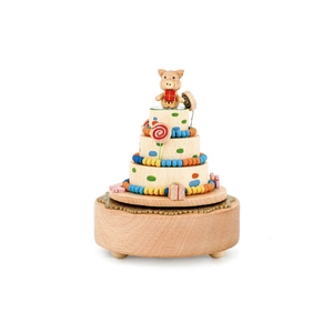 Colorful tiered cake wooden music box with small pig topper and vibrant hand-painted details
