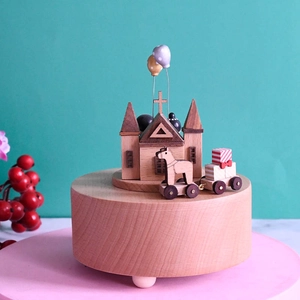 European wooden music box with carousel and castle on a round base for weddings