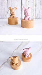 Detail of handcrafted beech wood music box with cute cartoon figure and smooth finish