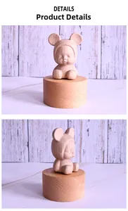 Detailed views of a sleeping baby wooden music box figurine in a bear costume