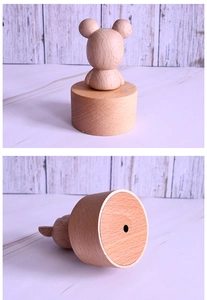 Close-up of the base and smooth wooden texture of a handmade bear music box