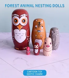 Detailed set of 6 forest animal nesting dolls featuring owls and tigers on marble surface