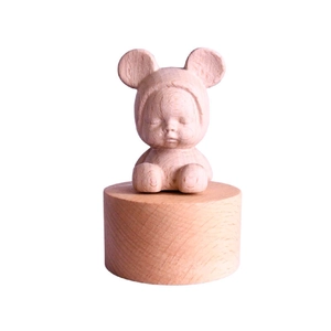 Carved wooden baby music box made of natural beech wood with a minimalist sleepy design