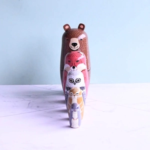 Modern wooden nesting dolls set featuring painted forest animals like bear and fox
