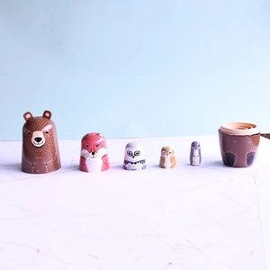 Handcrafted wooden Russian nesting dolls featuring hand-painted forest animal designs