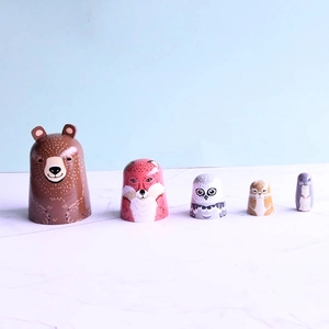 Set of 5 wooden nesting dolls featuring hand-painted forest animals like bear and fox