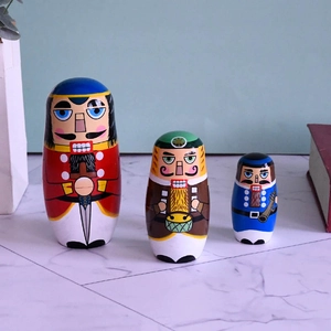 Three-piece set of wooden hand-painted Nutcracker nesting dolls in festive soldiers design