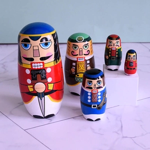 Detail of five-piece nesting dolls featuring nutcracker soldier designs and vivid painted colors