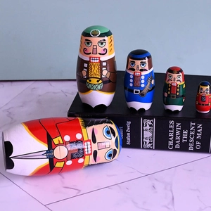 Detailed view of 5-piece nutcracker soldier nesting dolls on a decorative marble surface