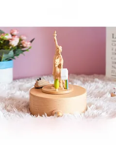 Macro view of wooden Statue of Liberty music box with rotating cruise ship and rainbow detail