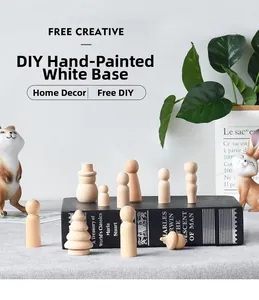 Close-up of unfinished wooden peg dolls and mushroom figurines for DIY painting crafts