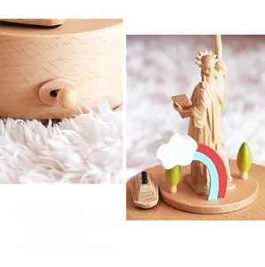 Detailed view of handcrafted 3D Statue of Liberty wooden music box with rainbow and boat