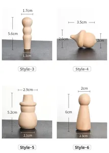 Detailed view of four unfinished natural wooden figures for DIY painting and crafts