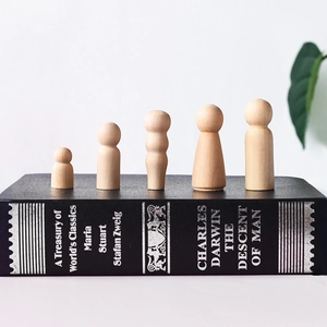 Detailed view of 5 unfinished wooden peg dolls in different shapes for DIY crafts