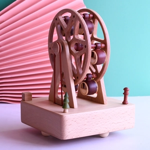 Handcrafted beech wood Ferris wheel music box featuring natural textures and crimson accents