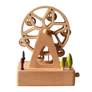 Rotating wooden Ferris wheel music box with miniature trees on a natural wood base