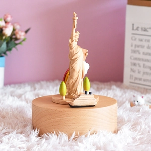 Rotating 3D wooden Statue of Liberty music box with carved rainbow and ship decor