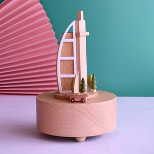 Wooden Burj Al Arab music box featuring miniature Dubai landmarks and a small boat
