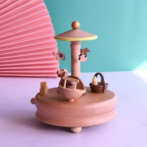 Handcrafted wooden musical box with rotating animal charms and mechanical wind-up base