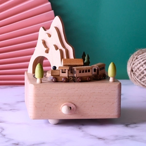 Detail of wooden Alishan train music box featuring mountain scenery and rolling train