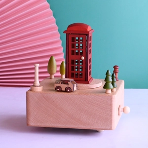 Detailed macro view of a vintage British red telephone box and wooden car on a music box