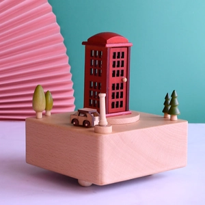 Wooden music box with vintage red telephone booth, mini car, and trees on a solid wood base