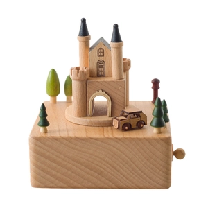 European castle beech wood music box with miniature car and trees on white background
