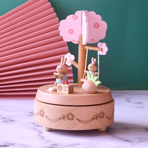 Wooden rabbit flower garden music box with a pink cherry blossom tree on a round base