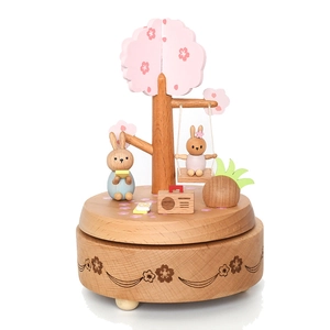 Wooden music box featuring a cherry blossom tree and rabbits on a white background