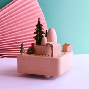 Handcrafted beech wood Christmas music box featuring a moving train and festive tree