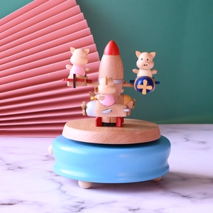Wooden rocket music box with colorful pigs flying planes, rotating creative gift for kids