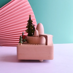 Detail of wooden Christmas music box with festive tree, train and mountain scenery