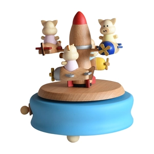 Handcrafted wooden music box featuring spinning rocket and cartoon pigs in airplanes