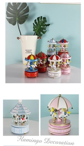 Detail showing various colors of wooden carousel music boxes with fine craftsmanship