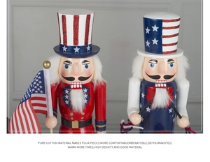 Detail of glitter finish American flag nutcracker puppet with red and blue patriotic motifs