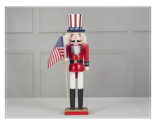 Detail of wooden nutcracker soldier holding an American flag with red and blue star patterns