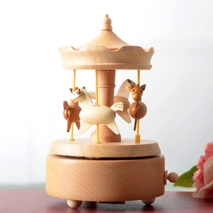 Handcrafted wooden carousel music box with natural grain and three rotating horses