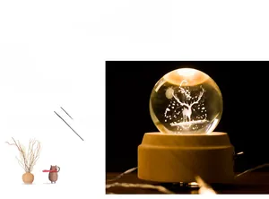 Detail showing 3D laser engraved elk crystal ball with illuminated solid wood base