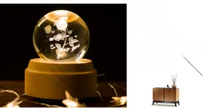 Detail of 3D crystal ball music box with laser-engraved rose and LED wooden base