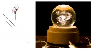Detailed 3D laser-engraved galaxy inside a crystal ball on a warm wooden base