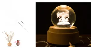 Close-up of 3D laser-engraved carousel crystal ball with warm glowing wooden base