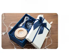 Detailed gift box view containing a glowing crystal ball and beech wood LED base with USB cable